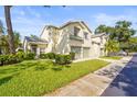 Charming two-story home with a well-maintained lawn and mature trees at 6310 Green Oak Cir, Bradenton, FL 34203