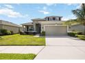 Charming two-story home features a well-manicured lawn and a spacious two-car garage at 6377 Mighty Eagle Way, Sarasota, FL 34241