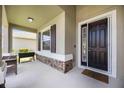 Inviting front porch with stone accents, a dark wood door and a new grill at 6377 Mighty Eagle Way, Sarasota, FL 34241