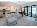 Open concept living space with modern finishes, tile flooring, and seamless access to an outdoor patio at 6714 Alstead Cir, Bradenton, FL 34202