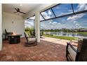 Covered patio with beautiful water views, brick pavers, and comfortable seating perfect for relaxing at 6714 Alstead Cir, Bradenton, FL 34202