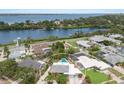 Aerial view of a beautiful home with a pool, backing up to a river with waterfront properties at 715 Fontana Ln, Bradenton, FL 34209