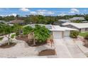Charming single-story home with manicured front yard, shade tree, and driveway leading to a two-car garage at 715 Fontana Ln, Bradenton, FL 34209