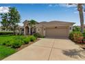 Beautiful home exterior showing driveway leading to a two-car garage with mature landscaping at 730 Old Quarry Rd, Bradenton, FL 34212