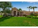 Inviting single-story house showcases a well-manicured lawn and beautiful landscaping in a tranquil neighborhood at 730 Old Quarry Rd, Bradenton, FL 34212