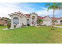 Charming single-story home with a well-manicured lawn and a beautiful red tile roof at 7327 38Th Court East, Sarasota, FL 34243