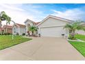 Single-story home with a 2-car garage, lush lawn, and manicured landscaping, offering curb appeal at 7327 38Th Court East, Sarasota, FL 34243