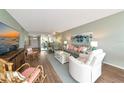 Open-concept living area with a view of the dining space, comfortable seating, and bright natural light at 7461 W Country Club N Dr # 203, Sarasota, FL 34243