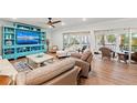 Comfortable living room with modern furnishings, entertainment center, and sliding doors to a balcony at 101 Whispering Sands Dr # 307, Sarasota, FL 34242