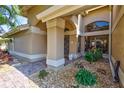 Inviting front porch with decorative stone landscaping, elegant pillars, and a stylish front door at 105 Inlets Blvd # 105, Nokomis, FL 34275