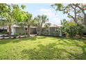 A beautiful home featuring lush tropical landscaping with palm trees and a manicured lawn at 1207 71St Nw St, Bradenton, FL 34209