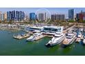 An aerial view of a marina with boats docked in the water and buildings in the background at 1233 N Gulfstream Ave # 401, Sarasota, FL 34236