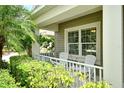 Inviting front porch with comfortable seating, offering a relaxing outdoor space with a charming neighborhood view at 12331 Halfmoon Lake Ter, Bradenton, FL 34211