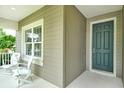 Charming front porch with cozy seating, a perfect spot to welcome guests to this inviting home at 12331 Halfmoon Lake Ter, Bradenton, FL 34211