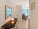 Inviting hallway showcasing neutral tones, tasteful decor, and seamless flow into the living area with tiled floor at 1350 N Portofino Dr # 402, Sarasota, FL 34242