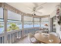 Bright and airy sun room boasting panoramic water views and comfortable seating area with tiled floor at 1350 N Portofino Dr # 402, Sarasota, FL 34242
