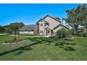 Charming two-story home with landscaped front yard and lush green lawn on a sunny day at 13514 4Th E Plz, Bradenton, FL 34212