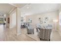 Bright living room with an open floor plan to the dining area with great lighting and plank flooring at 13606 Deep Blue Pl, Bradenton, FL 34211