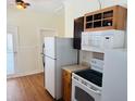 Kitchen featuring white appliances, wooden cabinets and ample counter space at 1412 12Th W Ave, Bradenton, FL 34205
