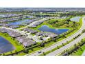 Panoramic aerial shot showcases a beautiful community with scenic lakes, lush greenery, and well-spaced homes at 16606 Barnwood Pl, Lakewood Ranch, FL 34211