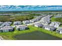 Beautiful aerial view of a neighborhood with lush green spaces, scenic lakes, and modern homes at 17715 Boracay Ct # 202, Venice, FL 34293