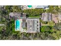 Aerial view of estate showcasing lush landscaping, pool, guest house, and privacy at 1774 Cherokee Dr, Sarasota, FL 34239