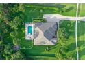 An aerial view of a beautiful property with a well-maintained yard and a sparkling blue pool at 22343 Panther Loop, Bradenton, FL 34202