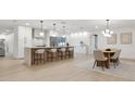 Bright, spacious kitchen featuring a waterfall island, barstool seating and contemporary design at 2430 Catalonia S Way, St Petersburg, FL 33712