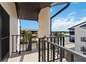 Balcony view overlooking the building's common area, pool, and waterway adding charm to this condominium complex at 2729 North Beach Rd # 212, Englewood, FL 34223