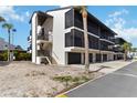 Attractive two-story condominium building offering private screened-in patios, convenient parking garages, and ample outdoor staircase access at 2729 North Beach Rd # 212, Englewood, FL 34223