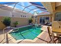 Beautiful screened-in pool with a built-in spa, a fountain, and brick patio at 303 9Th E Ave, Palmetto, FL 34221