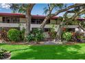 Exterior of the property featuring mature trees and landscaping at 3500 El Conquistador Pkwy # 128, Bradenton, FL 34210