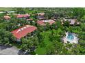 Community pool with lawn and mature landscaping at this townhome complex in a golf course community at 3500 El Conquistador Pkwy # 128, Bradenton, FL 34210