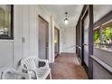 Enclosed porch with tile flooring and a serene view at 3500 El Conquistador Pkwy # 128, Bradenton, FL 34210