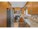 Well-lit kitchen features stainless steel appliances, granite countertops, and ample cabinet space at 3500 El Conquistador Pkwy # 132, Bradenton, FL 34210