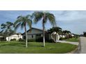 Charming single-story home with mature palm trees and lush green lawn at 3752 Collins St # 508, Sarasota, FL 34232