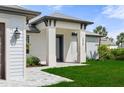 Inviting entrance showcasing the front door and the well-manicured lawn at 3865 Everglades Ter, North Port, FL 34286