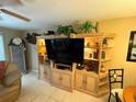 Bright living room boasts built-in shelving, housing a sleek television and decorative accents at 390 301 W Blvd # 2C, Bradenton, FL 34205