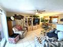 Bright living room featuring tile flooring, comfortable seating, and access to a screened porch at 390 301 W Blvd # 2C, Bradenton, FL 34205