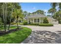 Expansive estate featuring lush green lawns and a circular brick driveway at 4224 Boca Pointe Dr, Sarasota, FL 34238