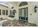 Elegant entryway showcasing a green front door with sidelights and transom window at 4224 Boca Pointe Dr, Sarasota, FL 34238