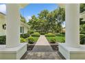 Manicured front lawn featuring a symmetrical walkway and lush landscaping at 4224 Boca Pointe Dr, Sarasota, FL 34238