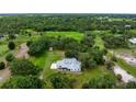Areal view showcasing a beautiful property surrounded by lush trees and large lawn at 4513 Hidden River Rd, Sarasota, FL 34240