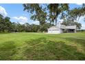Expansive green lawn leading up to a cozy home with a two-car garage and plenty of space for outdoor activities at 4513 Hidden River Rd, Sarasota, FL 34240