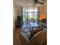 Living room with sliding glass door and hardwood flooring at 4520 47Th W Ave # 103, Bradenton, FL 34210