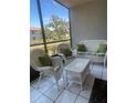Screened patio with white wicker furniture at 4520 47Th W Ave # 103, Bradenton, FL 34210