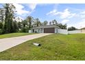 Beautiful home with a spacious yard and long driveway leading to the attached garage at 4565 Eldron Ave, North Port, FL 34286