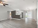 Open-concept living room with neutral tones, new floors, and lots of natural light at 4565 Eldron Ave, North Port, FL 34286