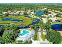 Stunning aerial view of a neighborhood showcasing lush landscaping, serene water views, and homes surrounding scenic lakes at 4958 Gardiners Bay Cir, Sarasota, FL 34238