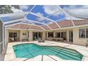 Inviting screened-in pool area with comfortable seating, perfect for outdoor relaxation and entertaining in the Florida sunshine at 4958 Gardiners Bay Cir, Sarasota, FL 34238